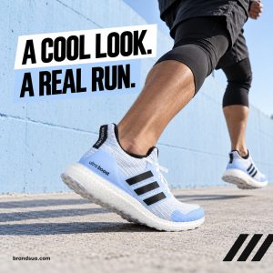 Adidas Ultraboost Game of Thrones EE3708 — Wide-low action photograph adult runner passing a clean pale blue concrete wall i…