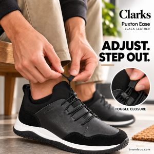 Clarks Puxton Ease Black Leather — Hand action demonstrates actual visible adjustment mechanism.