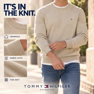 Tommy Hilfiger Pima Organic Cotton Cashmere — Adult actively pulls one cuff into place while walking, large torso hero plus…